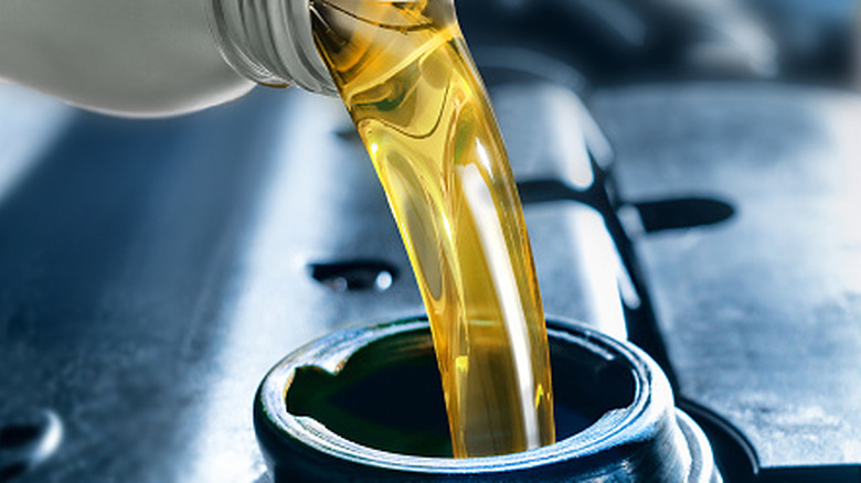 Close-up of oil being poured into an engine