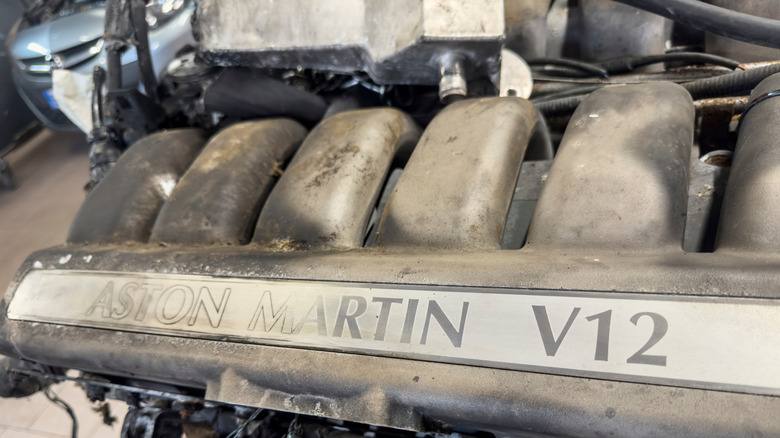 Aston Martin Lagonda V12 removed from vehicle, close-up of head cover reading, "Aston Martin V12"