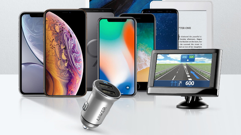 An Anker car USB charger in front of a lot of compatible devices, from phones to e-readers.