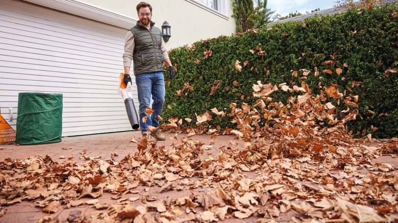 A man using a STIHL leaf blower with Constant Power technology