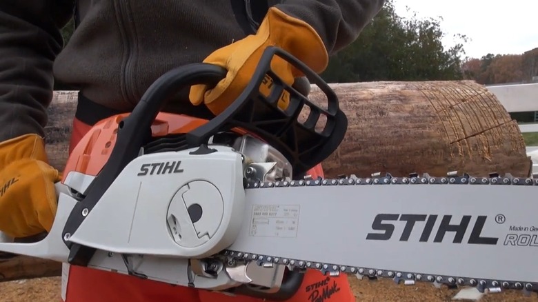 A man demonstrating STIHL's QuickStop technology by making the chain halt quickly