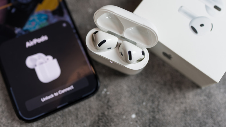 a pair of AirPods in the pairing process with an iPhone