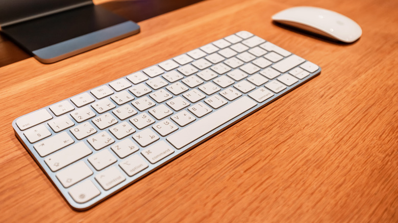 Magic keyboard and mouse on a desktop in front of a computer