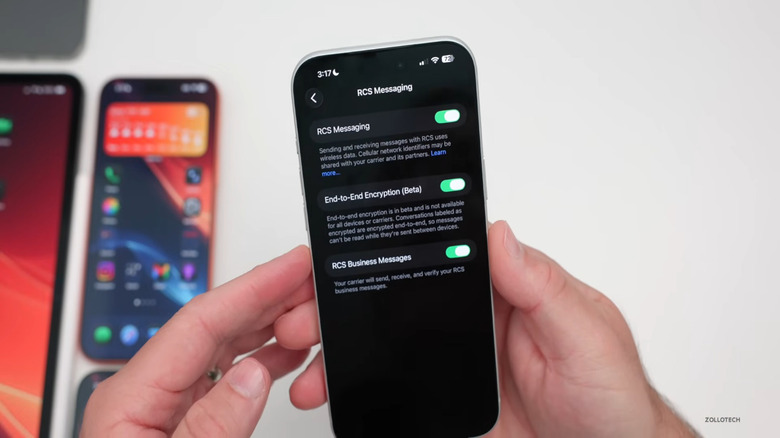 Aaron holding an iPhone with RCS end-to-end encryption settings