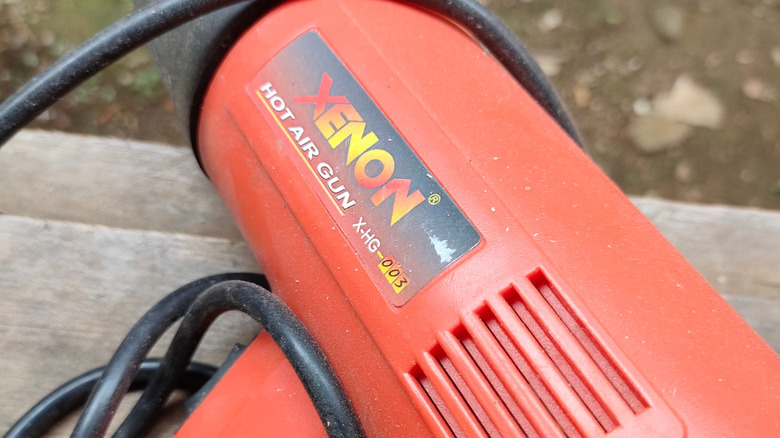 A hot air gun on a wooden surface.