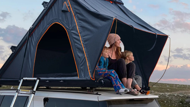 The Trustmade Scout Plus Triangle Aluminum rooftop tent on a silver SUV