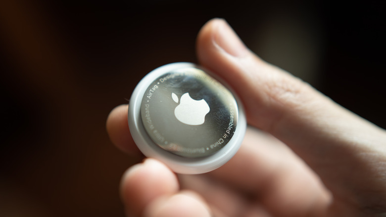 Person holding an Apple AirTag