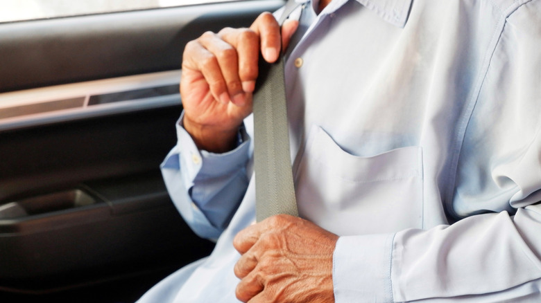 Close-up of an older man wearing a grey seatbelt