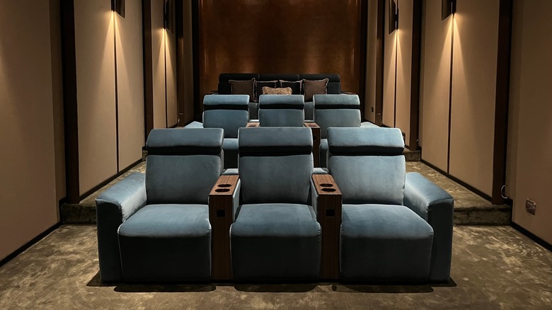 Three rows of seats in a mini home theater room.