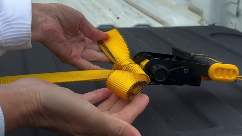 A DeWalt ratchet strap tied up.