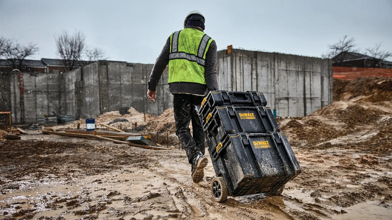 DeWalt Tough System 2.0 DS450 Mobile Tool Box carried across a workplace.