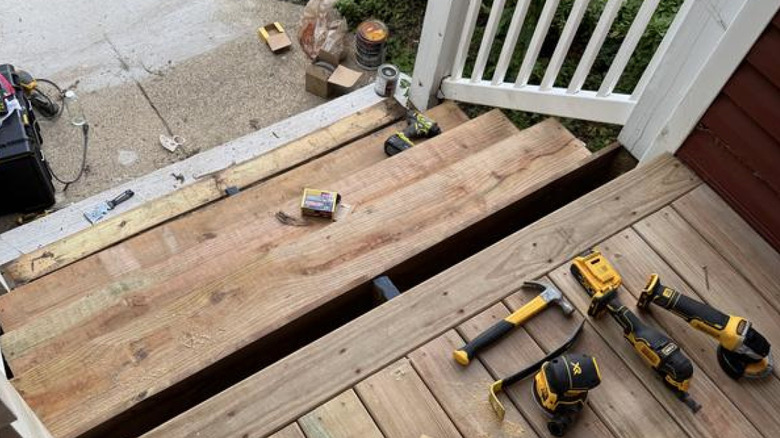 Person using DeWalt 10-piece kit on outdoor stairs
