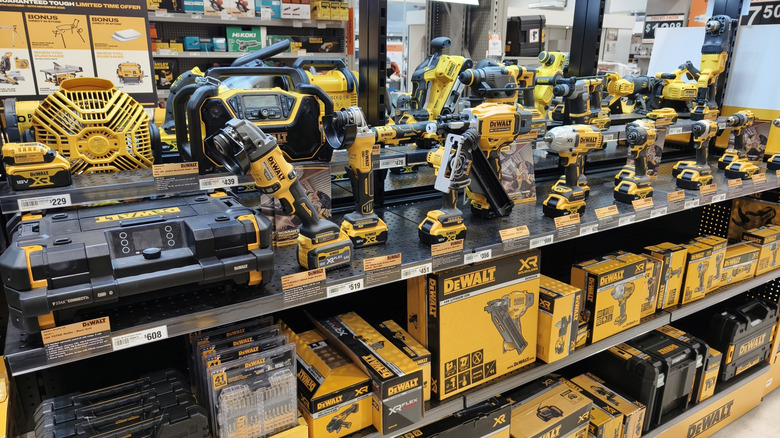 A retail display of various DeWalt power tools and accessories