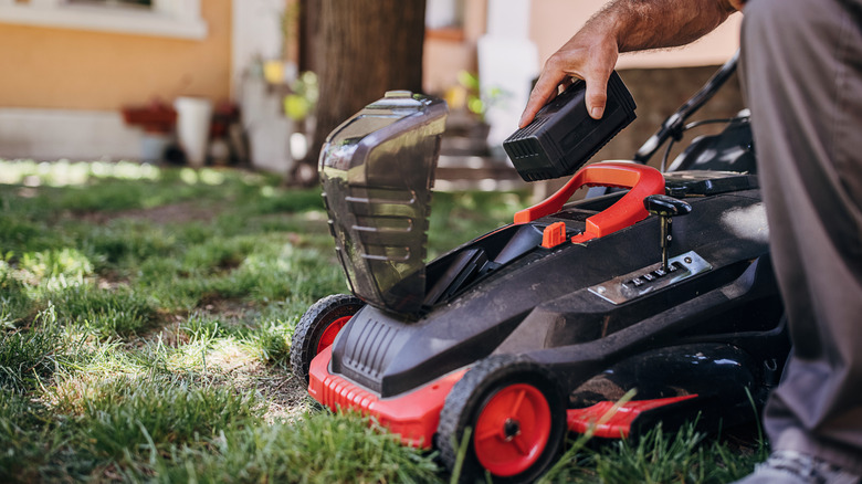 Handling a removable component of a battery-powered mower.