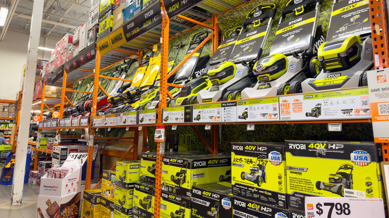 Lawn mowers on sale in a store.