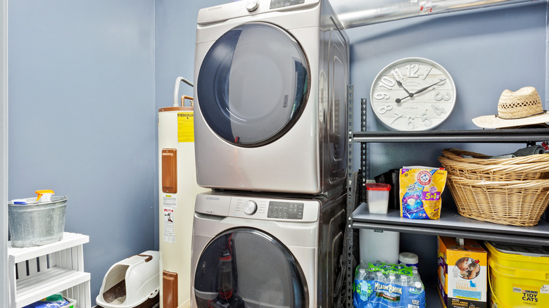 A washer and dryer stacked in a closet.