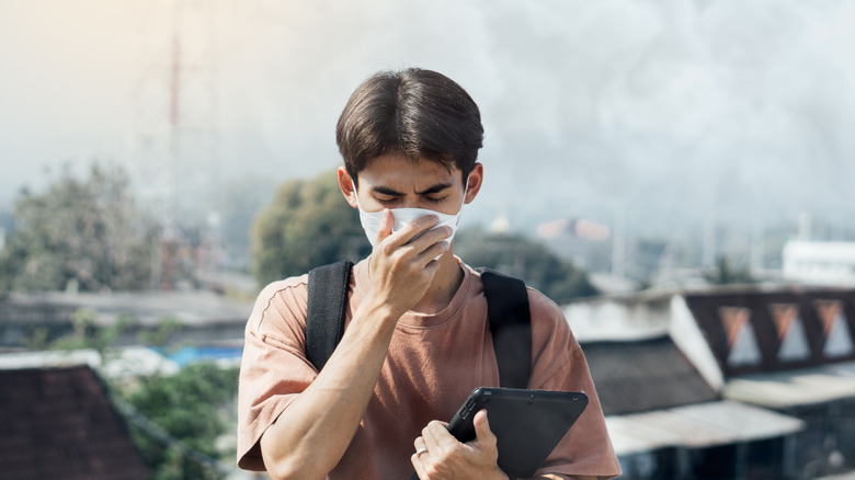 Person wearing face mask to protect from air pollution.