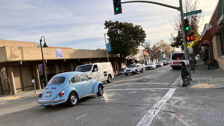 1972 Volkswagen Beetle driving on a city street
