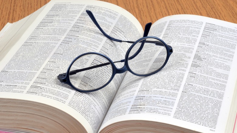 open dictionary with glasses