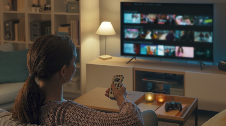 Woman watches smart tv in living room