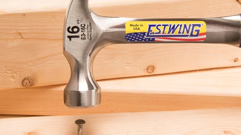 An Estwing hammer above a nail.