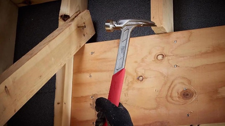 Milwaukee framing hammer being used on nail