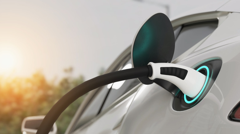 Close-up of an EV plugged in at a charging station