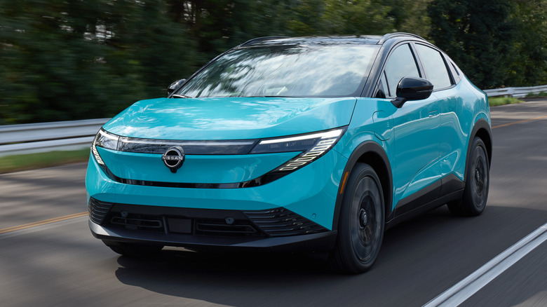 The 2026 Nissan Leaf in bright blue driving on a paved road