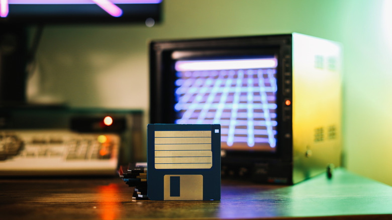 A floppy disk and an old CRT monitor on a table