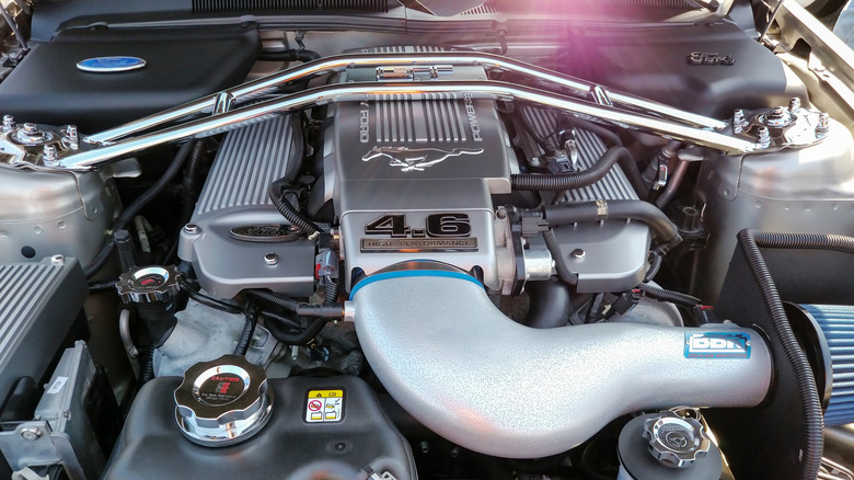 A close-up of a Ford 4.6 V8 engine in a Mustang engine bay.
