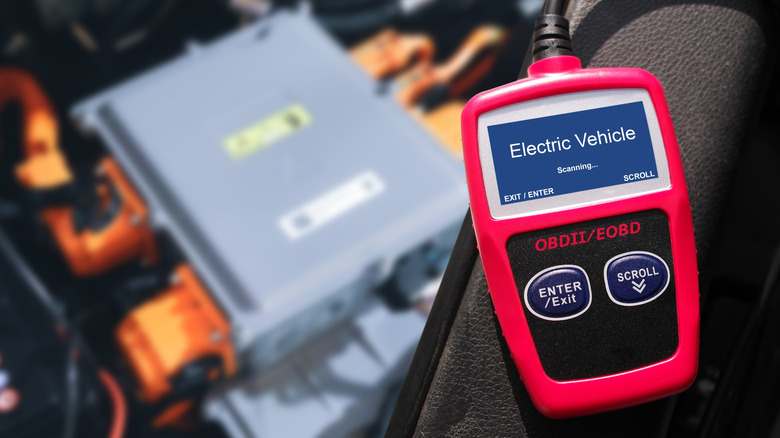 OBD-II car diagnostic tool scanning a vehicle