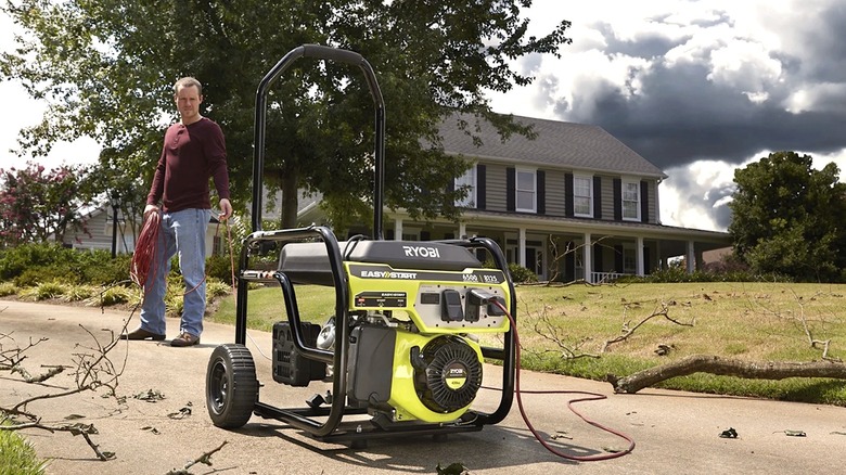A person looking at a gas powered Ryobi generator