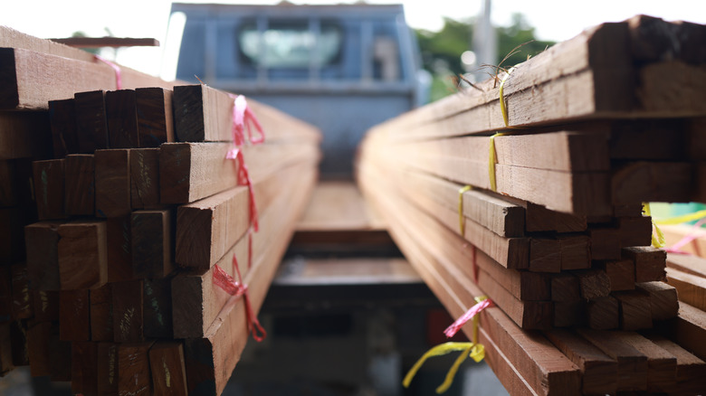 Close-up of lumber marked with red and yellow tags in the back of a pickup truck