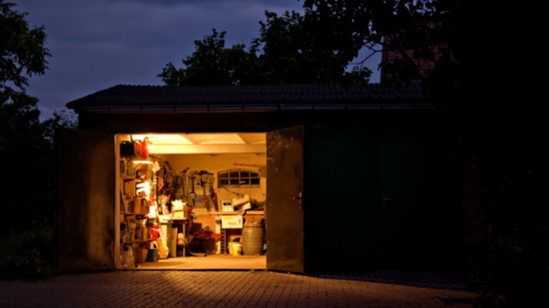 Open garage doors, with light turned on.