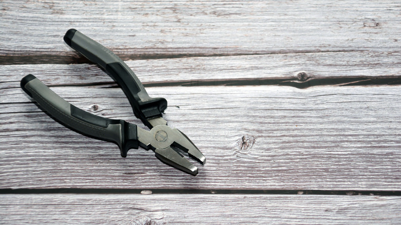 A pair of pliers on a wooden floor