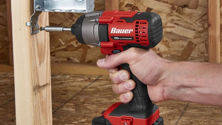 A person using a Harbor Freight bauer 20-volt impact driver