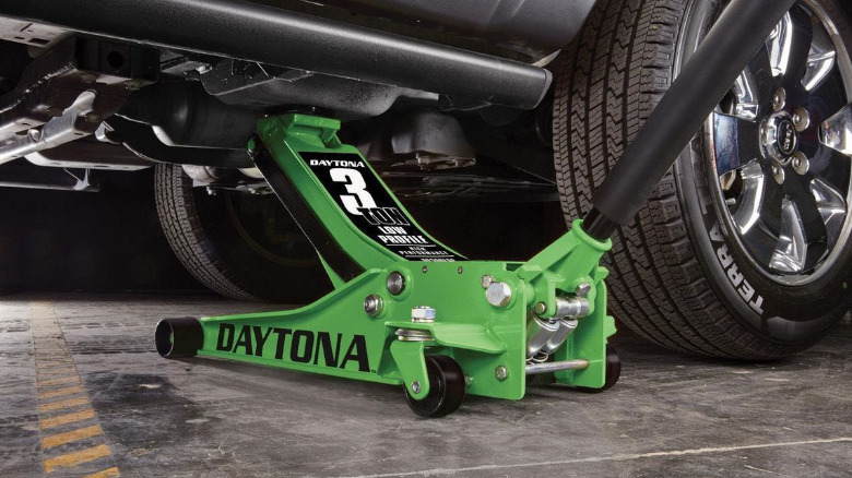 The Daytona 3 Ton Low-Profile Floor Jack with Rapid Pump under a car.