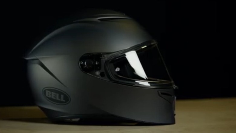 A full face Bell motorcycle helmet sitting on a table during a presentation by Bell Helmets.