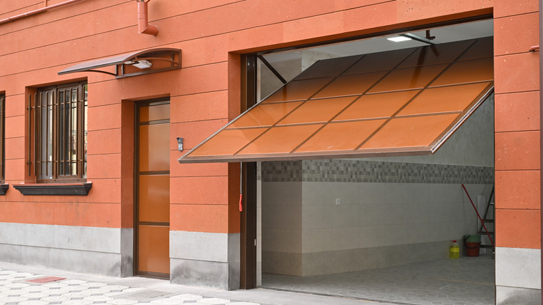 A half-open brown tiled garage door, revealing a clean and tidy interior