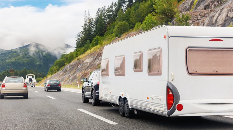 RV on mountain road back view
