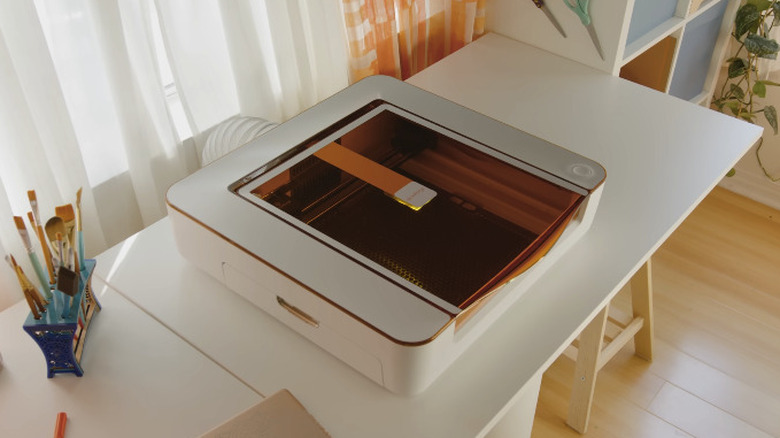 The Glowforge Aura 6W Laser Engraver and Cutter machine on desktop