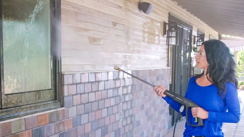 A person using Sun Joe SPX3000 Pressure Washer on windows