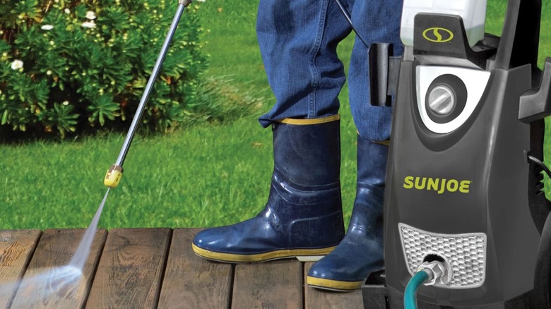 man using Sun Joe SPX3000 Pressure Washer on deck