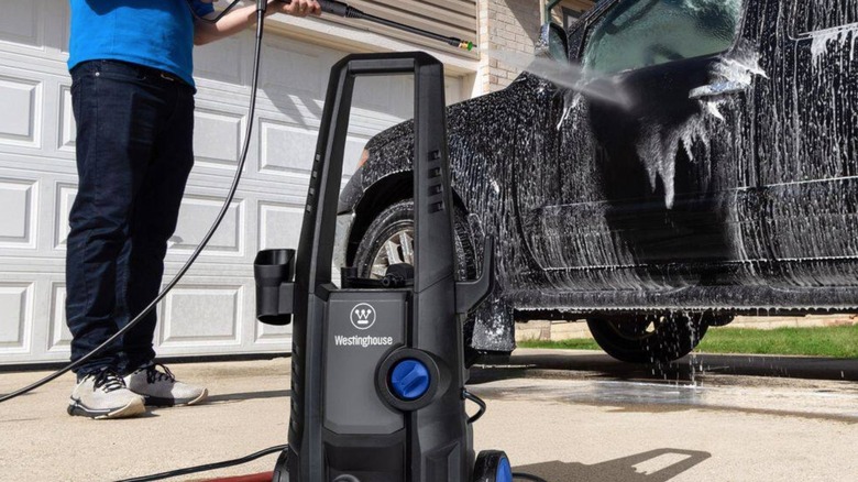 Person using Westinghouse pressure washer