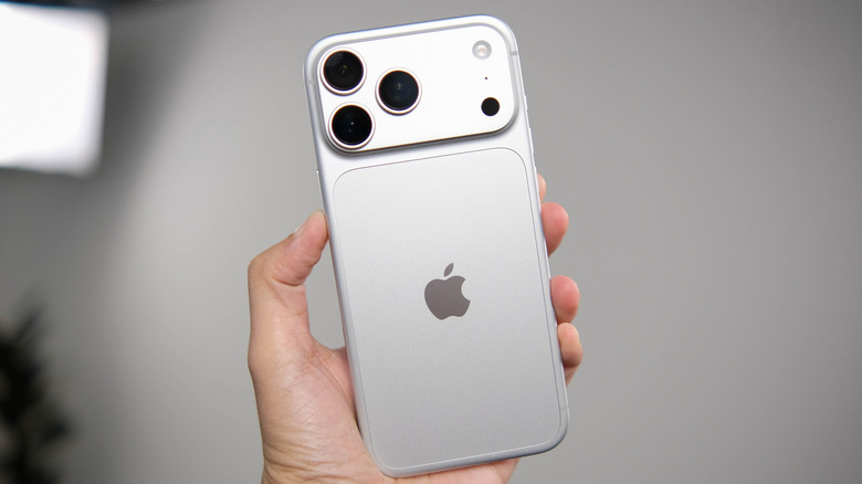 Hand holding up a silver iPhone 18 Pro.