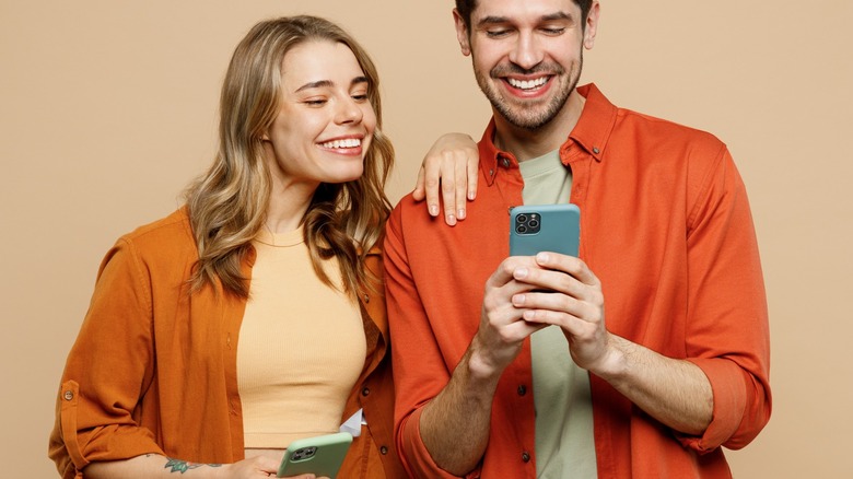 people smiling at their phones