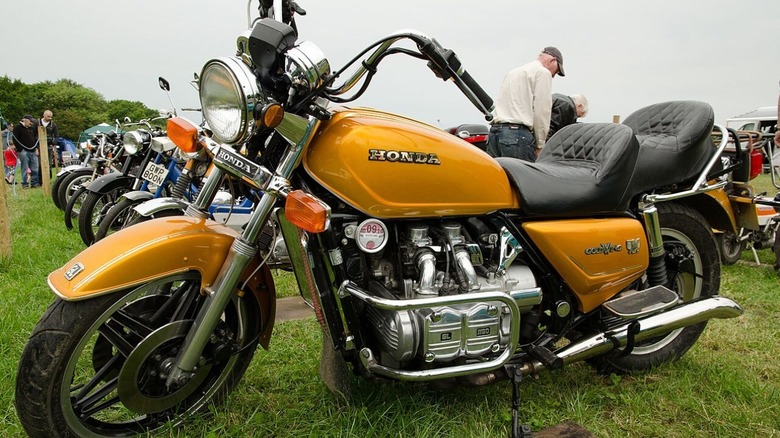 Honda GL1100 Gold Wing parked at outdoor event.