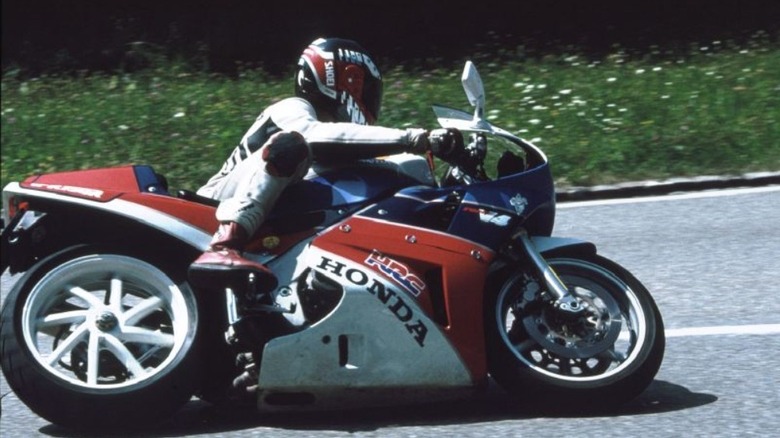 A rider taking a corner on a Honda VFR750R.