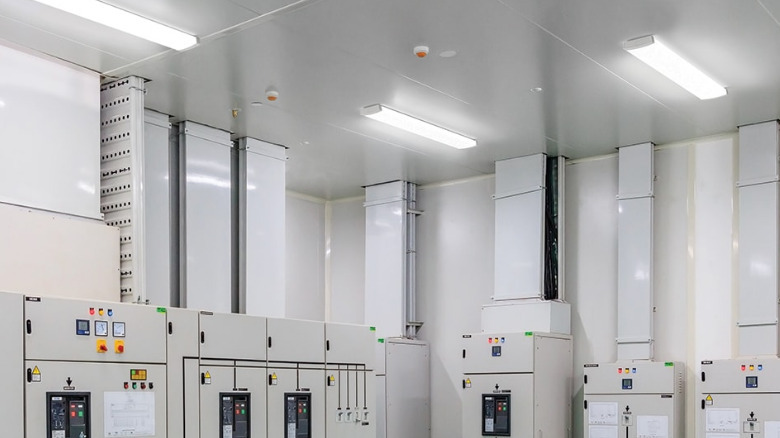 Tree Lithonia Lighting wraparound lights attached to a high ceiling.