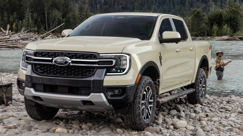 A beige 2026 Ford Ranger parked on a rocky riverbank
